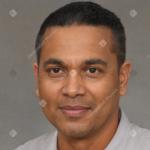 Joyful black adult male with short  black hair and brown eyes