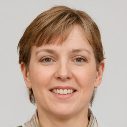 Joyful white adult female with medium  brown hair and grey eyes