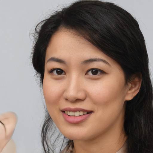 Joyful asian young-adult female with medium  brown hair and brown eyes