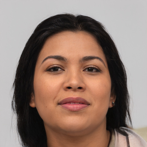 Joyful latino young-adult female with medium  brown hair and brown eyes