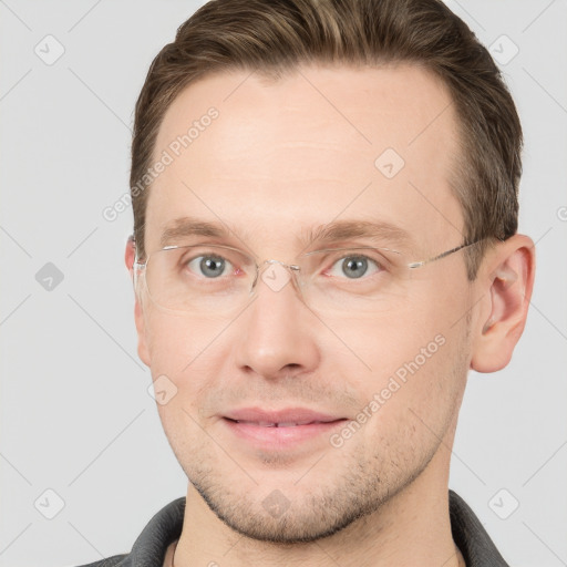 Joyful white adult male with short  brown hair and grey eyes