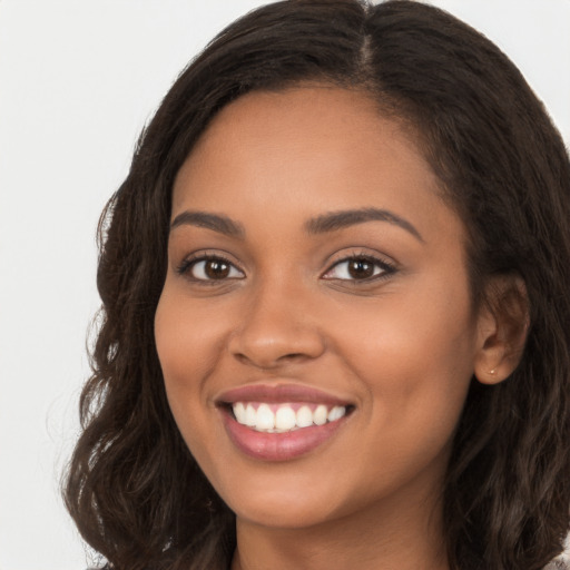 Joyful latino young-adult female with long  brown hair and brown eyes