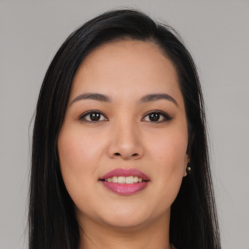 Joyful asian young-adult female with long  brown hair and brown eyes