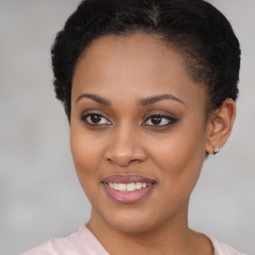 Joyful black young-adult female with short  brown hair and brown eyes