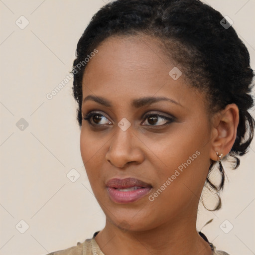 Joyful black young-adult female with short  brown hair and brown eyes