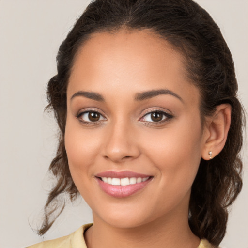 Joyful white young-adult female with long  brown hair and brown eyes