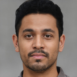 Neutral latino young-adult male with short  black hair and brown eyes