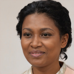 Joyful black adult female with medium  brown hair and brown eyes