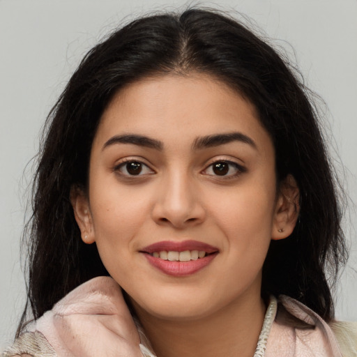 Joyful latino young-adult female with medium  brown hair and brown eyes