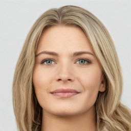 Joyful white young-adult female with long  brown hair and green eyes