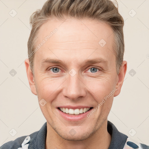 Joyful white adult male with short  brown hair and grey eyes