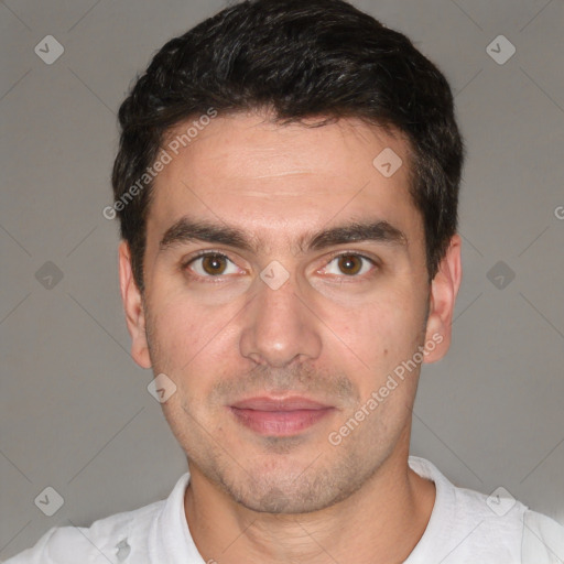 Joyful white young-adult male with short  black hair and brown eyes