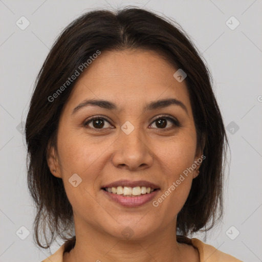 Joyful latino young-adult female with medium  brown hair and brown eyes