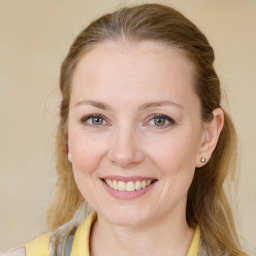 Joyful white young-adult female with medium  brown hair and blue eyes