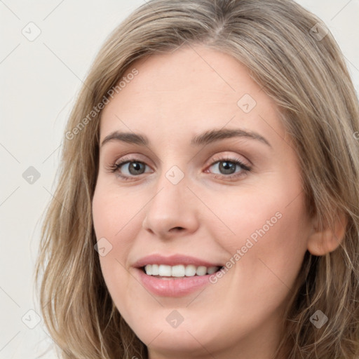 Joyful white young-adult female with long  brown hair and grey eyes