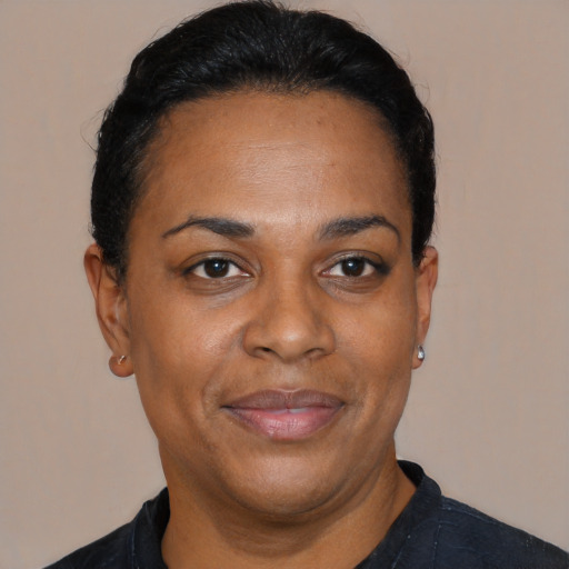 Joyful black adult female with short  black hair and brown eyes
