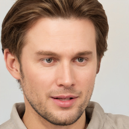 Joyful white young-adult male with short  brown hair and grey eyes