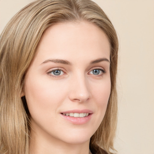 Joyful white young-adult female with long  brown hair and green eyes