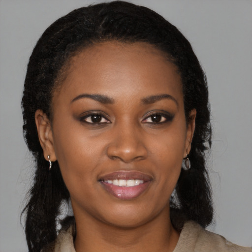 Joyful black young-adult female with long  brown hair and brown eyes