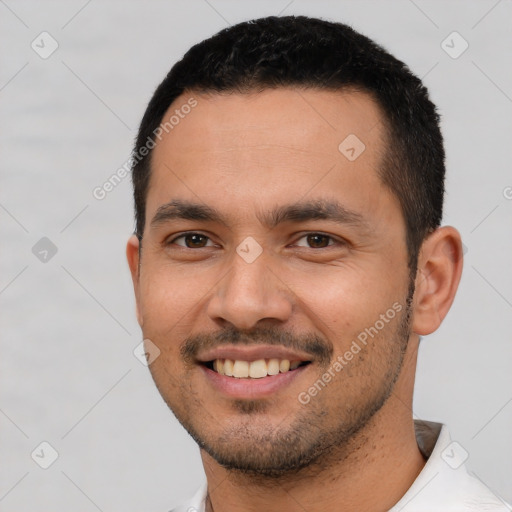 Joyful white young-adult male with short  black hair and brown eyes