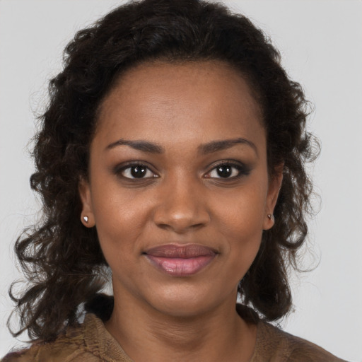 Joyful black young-adult female with medium  brown hair and brown eyes