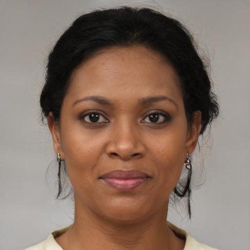Joyful black young-adult female with medium  brown hair and brown eyes