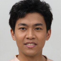 Joyful asian young-adult male with short  black hair and brown eyes