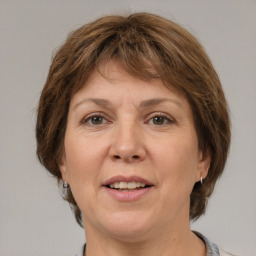 Joyful white adult female with medium  brown hair and grey eyes