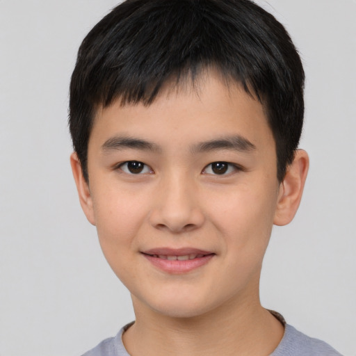 Joyful asian child male with short  black hair and brown eyes