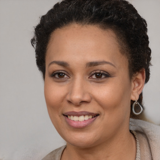 Joyful latino young-adult female with short  brown hair and brown eyes