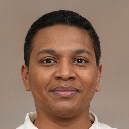 Joyful latino adult male with short  brown hair and brown eyes