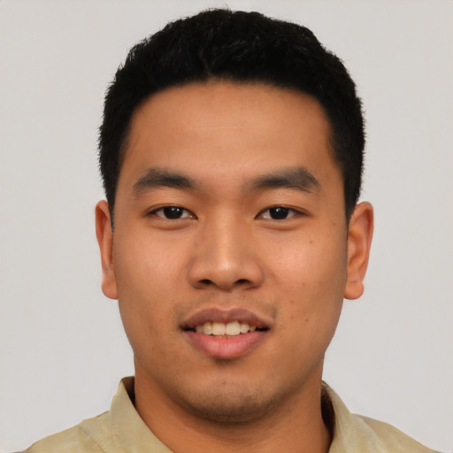 Joyful asian young-adult male with short  black hair and brown eyes