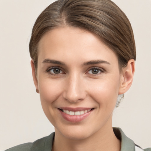 Joyful white young-adult female with medium  brown hair and grey eyes