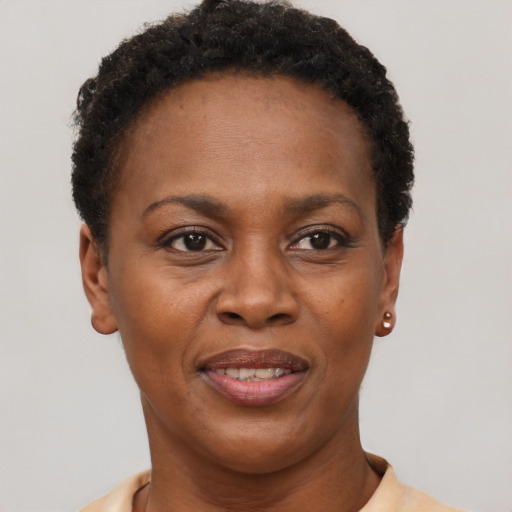 Joyful black adult female with short  brown hair and brown eyes