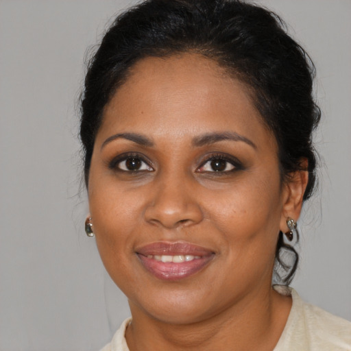 Joyful black young-adult female with medium  brown hair and brown eyes