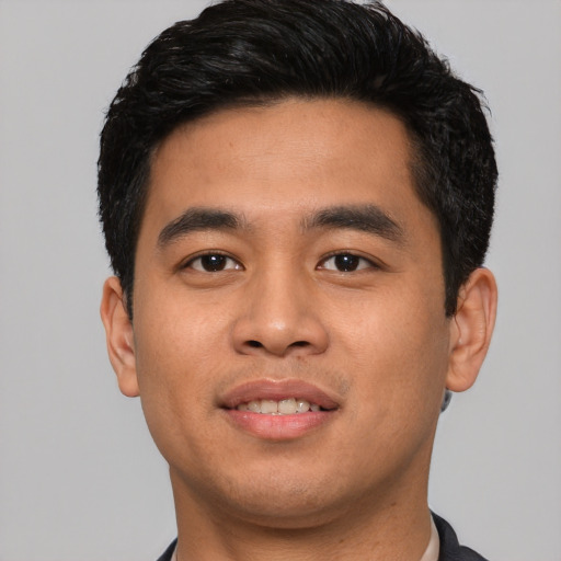 Joyful latino young-adult male with short  black hair and brown eyes