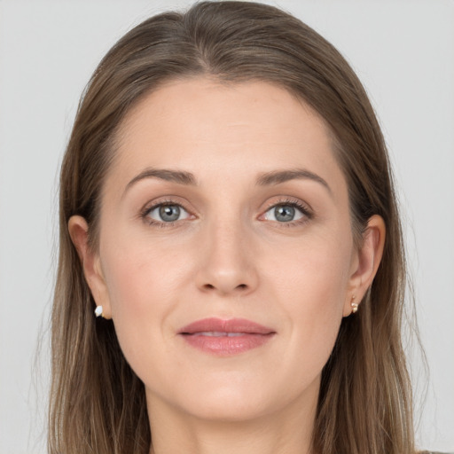 Joyful white young-adult female with long  brown hair and grey eyes