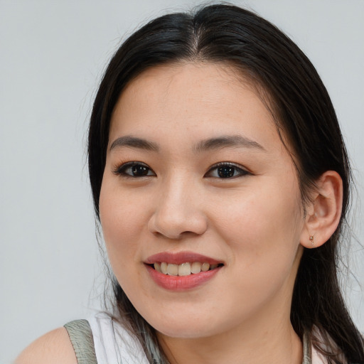 Joyful asian young-adult female with long  brown hair and brown eyes