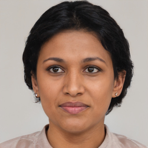 Joyful latino adult female with short  black hair and brown eyes
