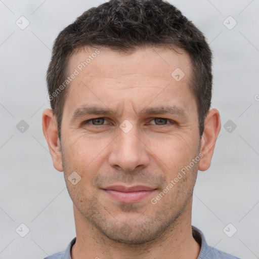 Joyful white adult male with short  brown hair and brown eyes