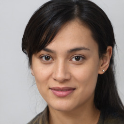 Joyful asian young-adult female with long  brown hair and brown eyes