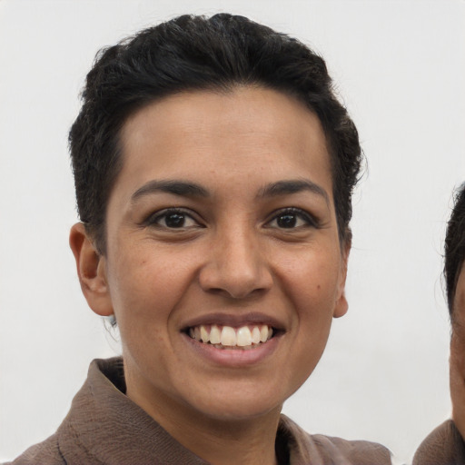 Joyful latino young-adult female with short  brown hair and brown eyes