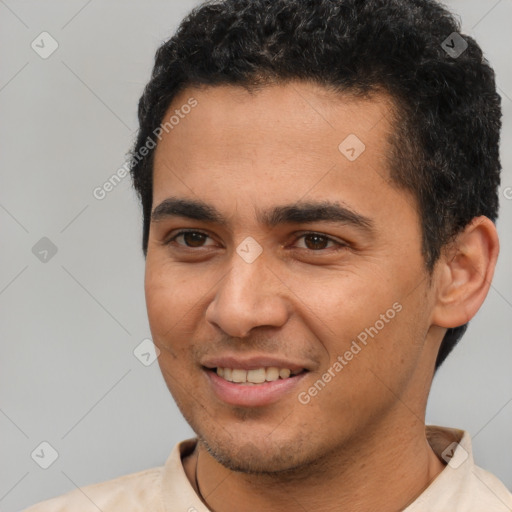 Joyful latino young-adult male with short  brown hair and brown eyes