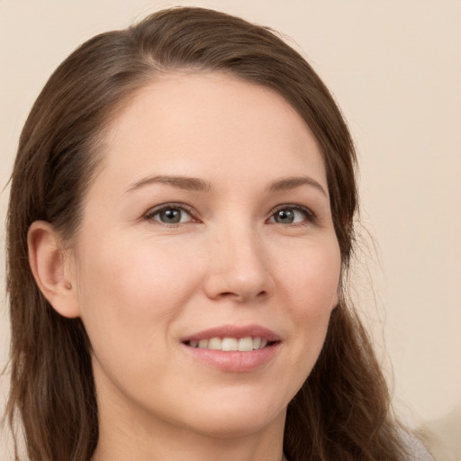 Joyful white young-adult female with long  brown hair and brown eyes