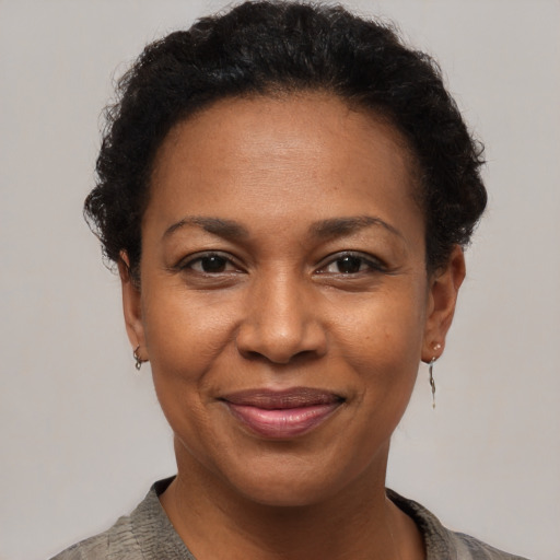 Joyful black adult female with short  brown hair and brown eyes