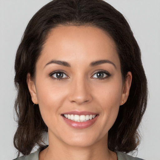 Joyful white young-adult female with medium  brown hair and brown eyes