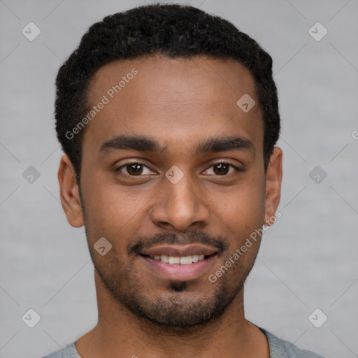 Joyful black young-adult male with short  brown hair and brown eyes