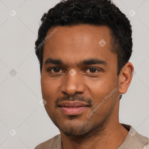 Joyful black young-adult male with short  black hair and brown eyes