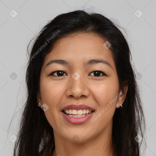 Joyful latino young-adult female with long  brown hair and brown eyes