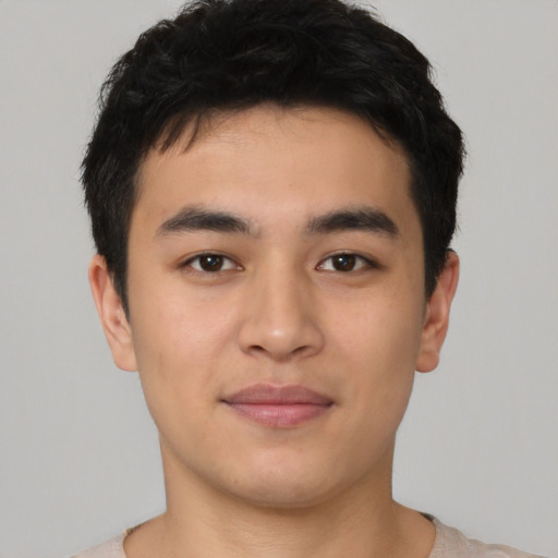 Joyful asian young-adult male with short  brown hair and brown eyes